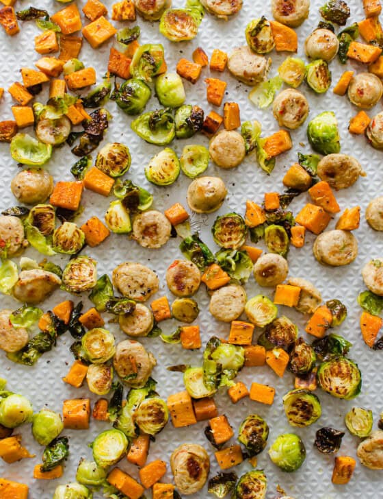 roasted sausage and veggies on a sheet pan after coming out of the oven