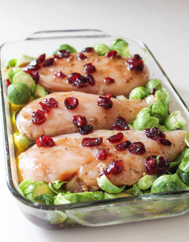 Cranberry balsamic chicken assembled in a 9x13 glass baking dish. 