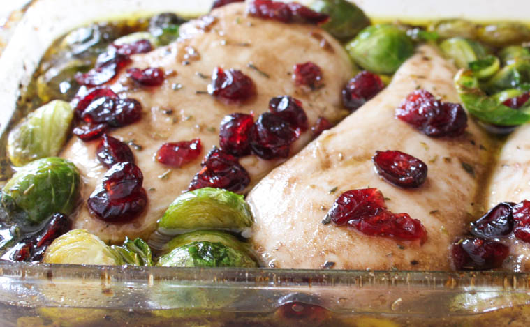 Cranberry balsamic chicken in baking dish straight out of the oven.