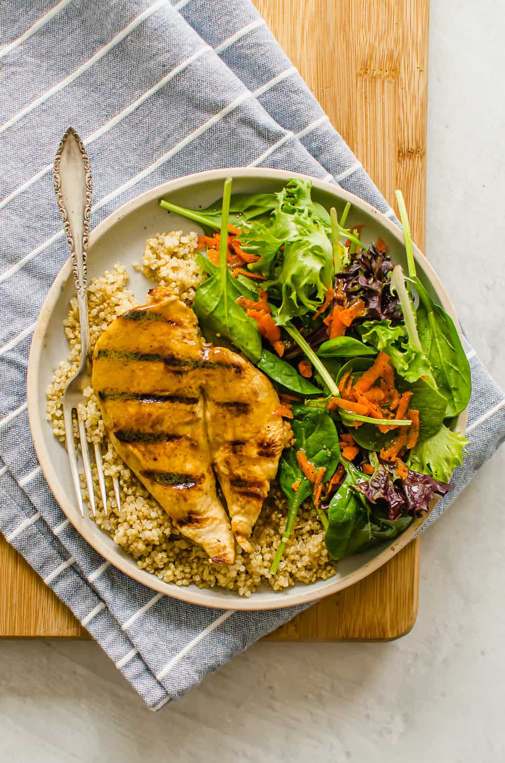 Honey Dijon Grilled Cutlet Chicken over quinoa with a side salad.