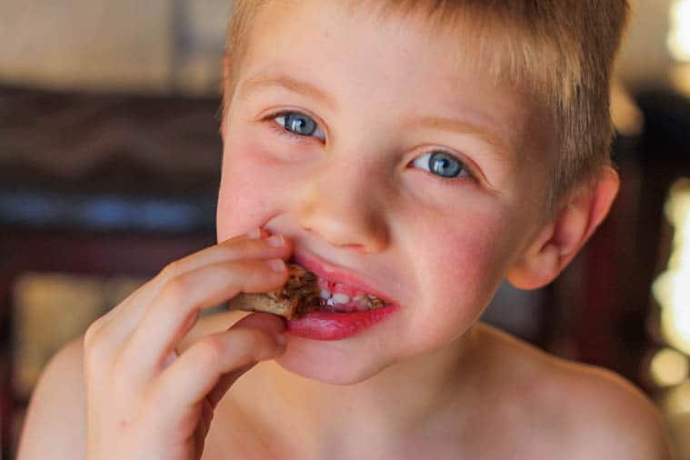 kid eating a tortilla cinnamon roll