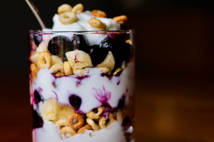 glass with yogurt, fruit, and cereal