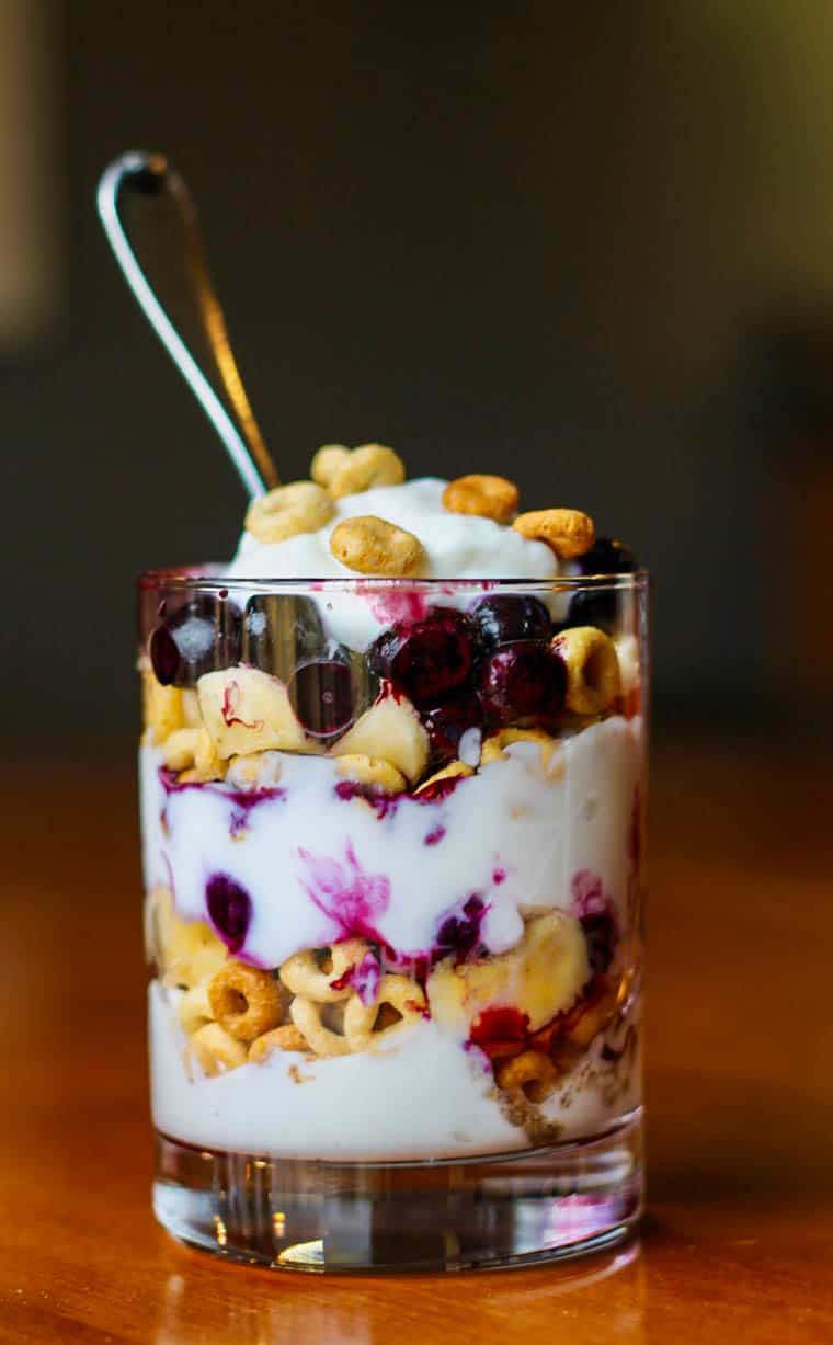 Breakfast Cereal Parfait made with layers of Cheerios, blueberries, and Greek yogurt.