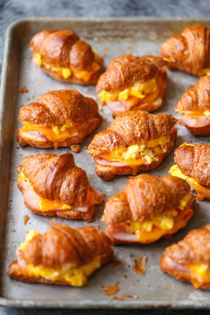 Freezer croissant breakfast sandwiches on a baking sheet straight from the oven.