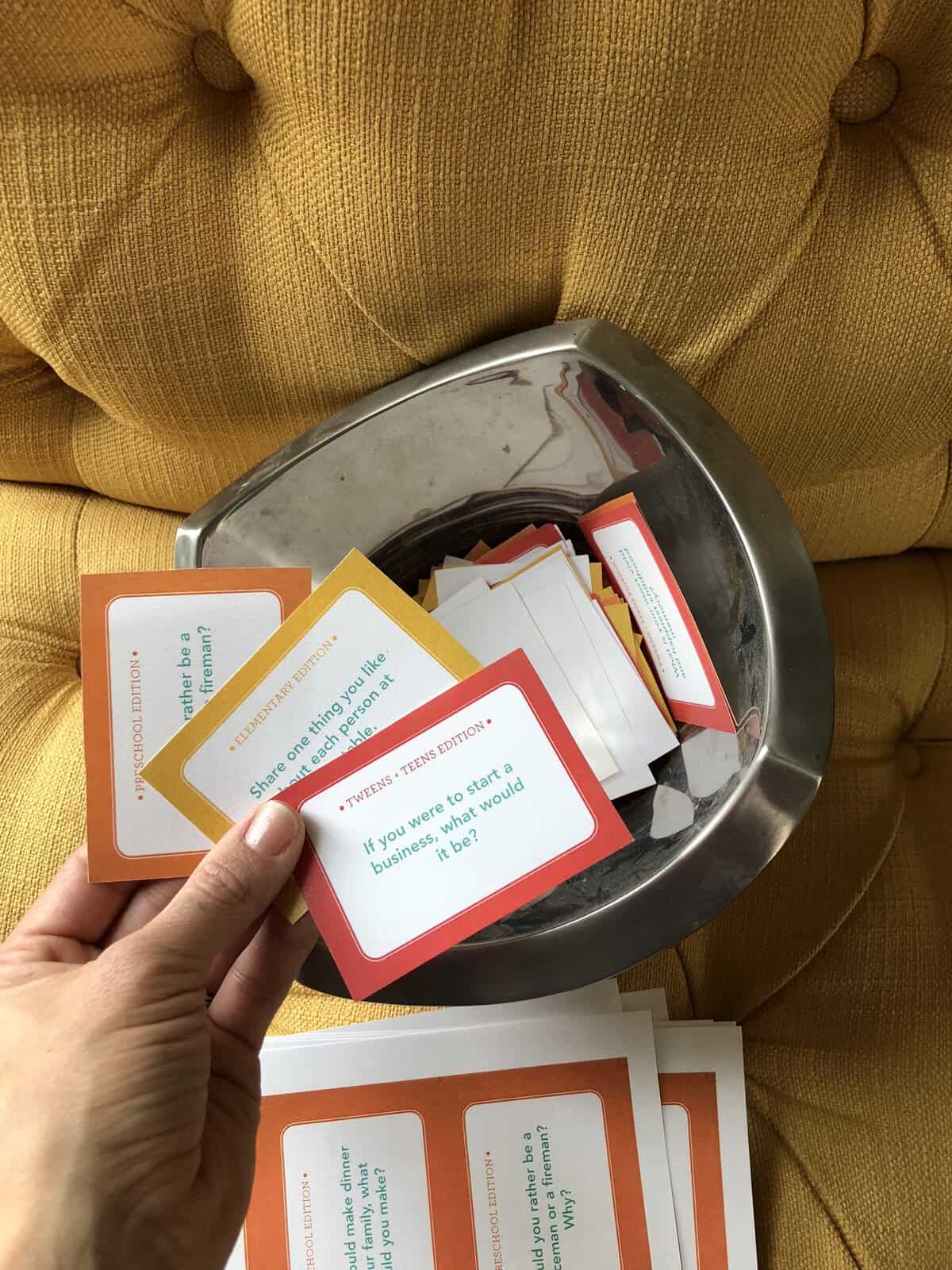 table talk cards that are cut up and put in a bowl.