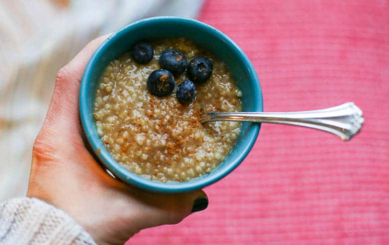 Hand holding a bowl of instant pot steel cut oatmeal