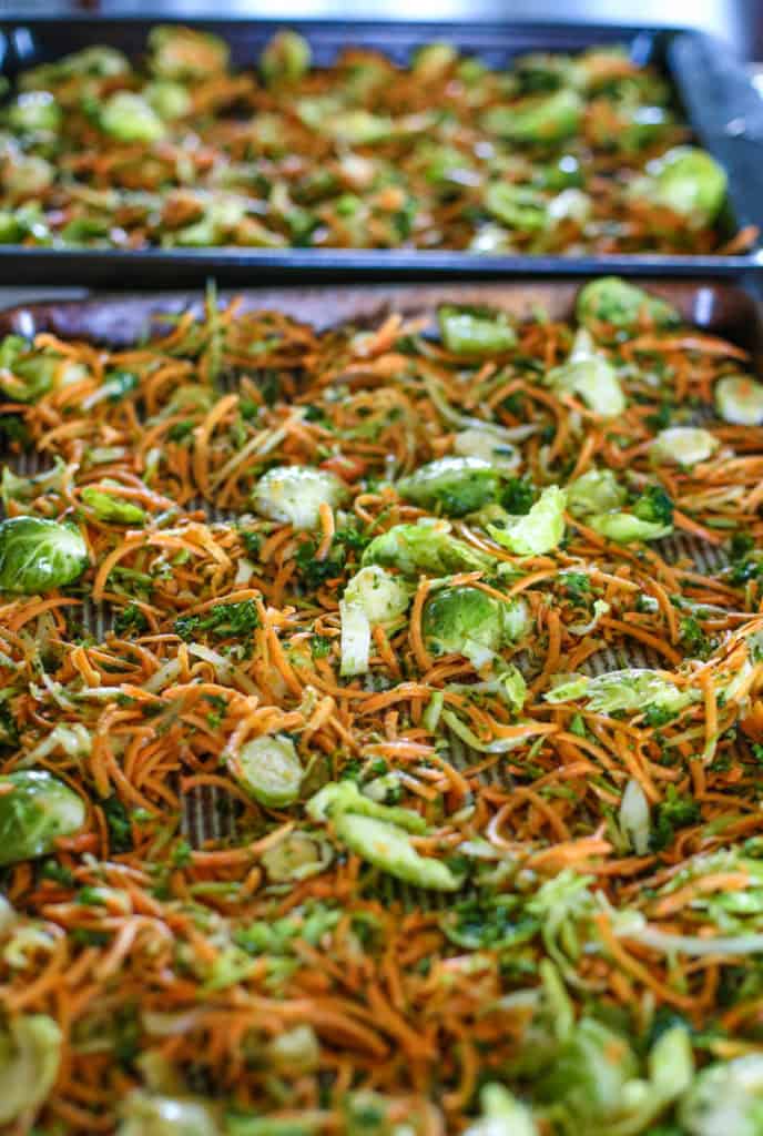 Raw shredded vegetables on a baking sheet