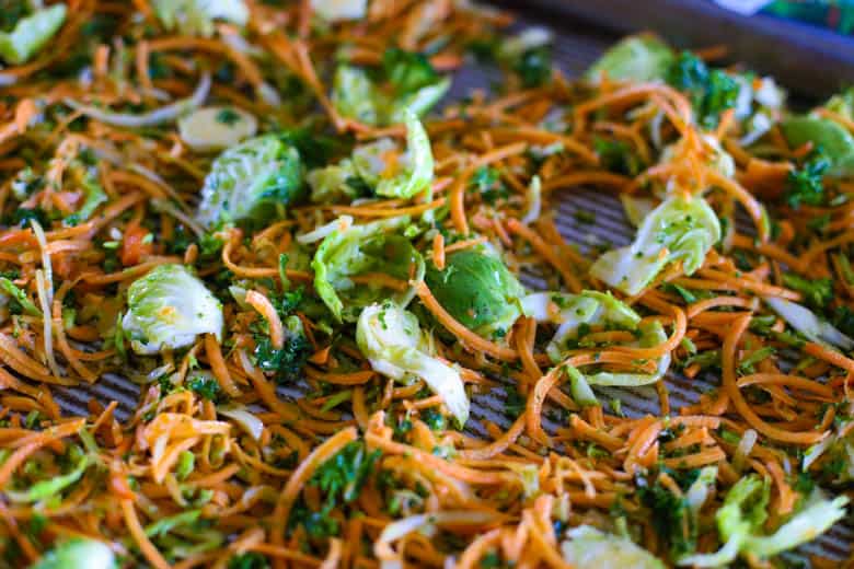 Raw shredded vegetables on a baking sheet