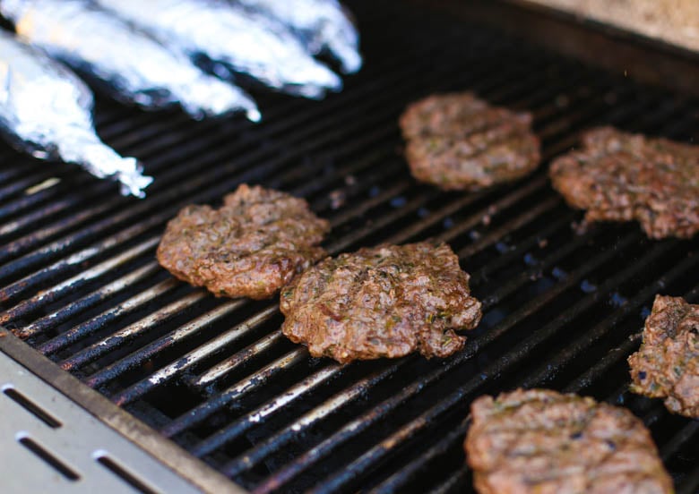 Pesto burgers on a grill 