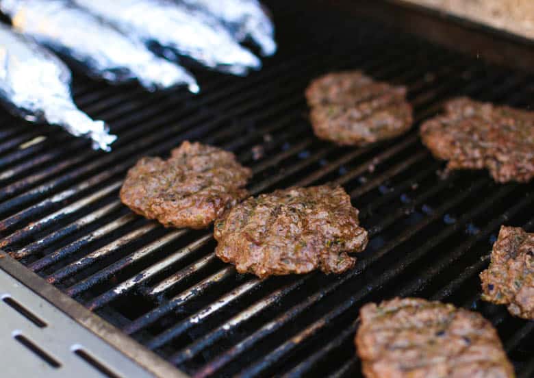 Pesto burgers on a grill.