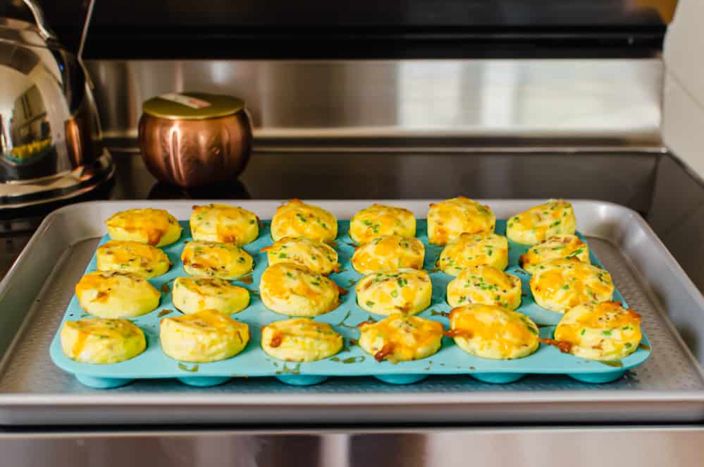 cheddar chive egg bites cooling after being in the oven