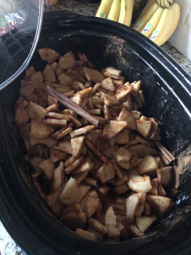 apple butter being cooked in a slow cooker