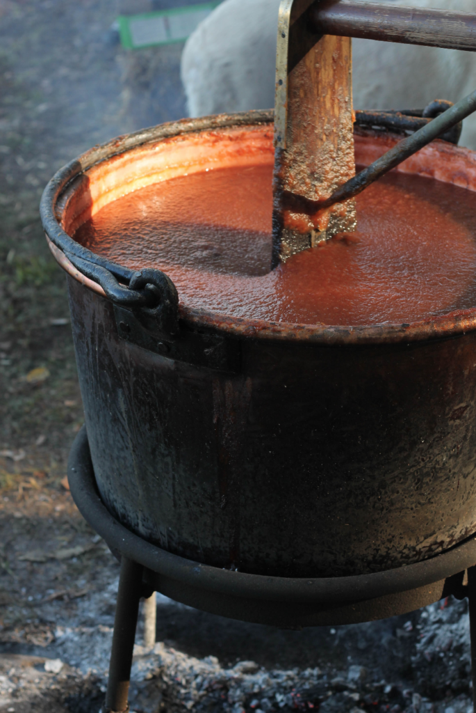 apple butter cooking in a copper pot