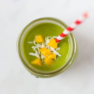 pineapple, mango, spinach, cashews on cutting board
