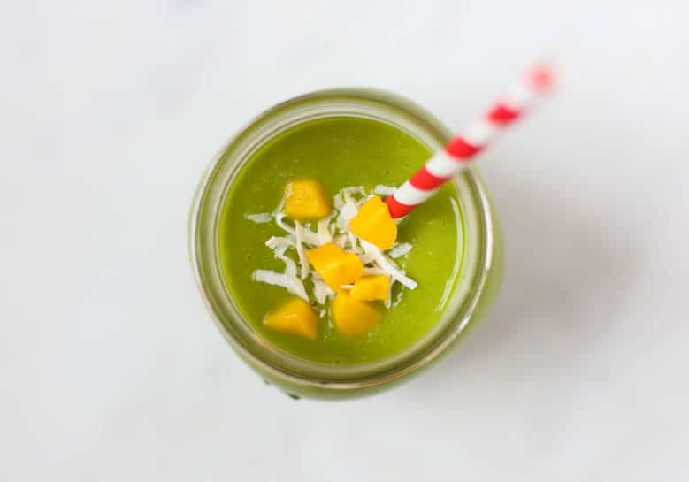 pineapple, mango, spinach, cashews on cutting board