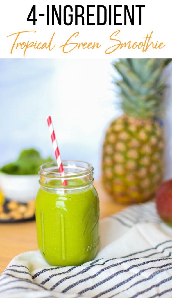 pineapple, mango, spinach, cashews on cutting board. Tropical smoothie recipe with a red straw. 