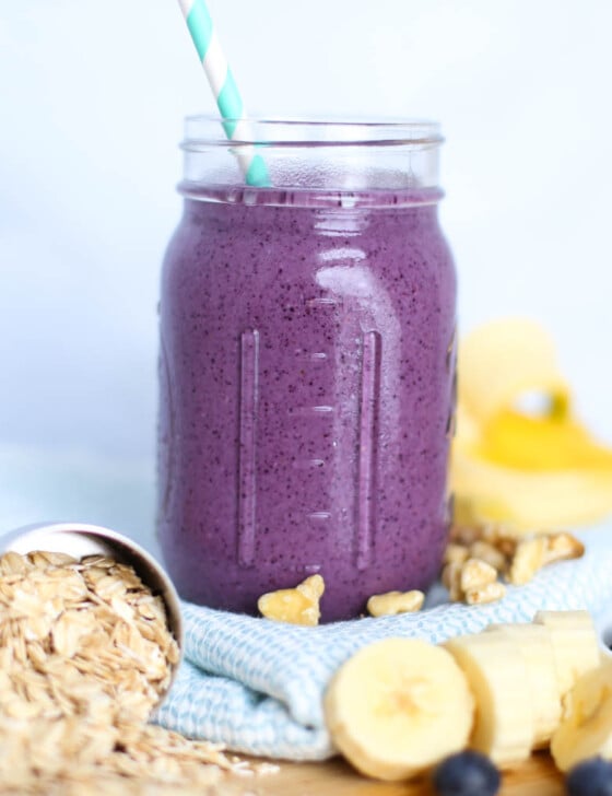 Blueberry muffin smoothie in mason jar with straw.