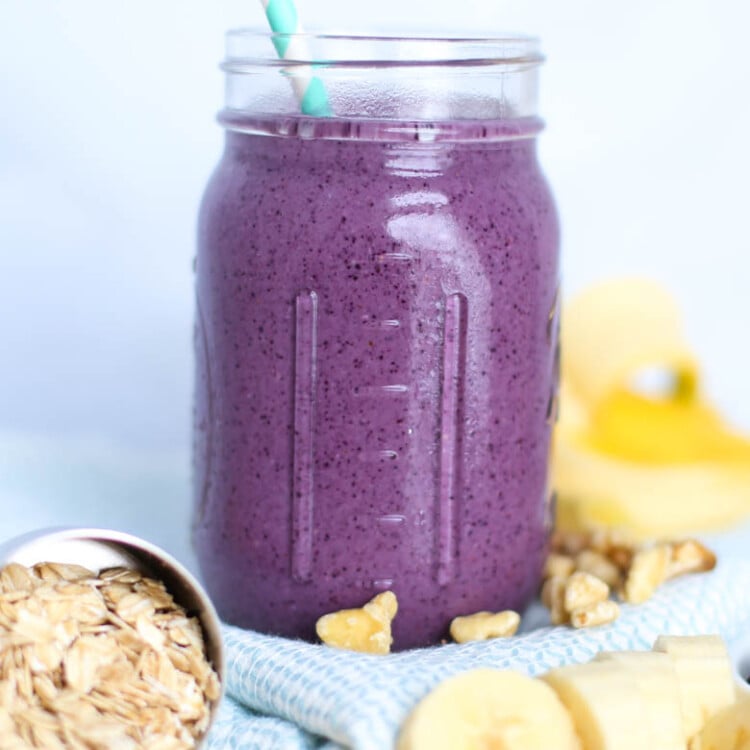 Blueberry muffin smoothie in mason jar with straw.