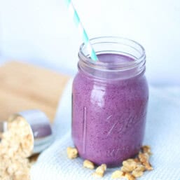 blueberry smoothie in mason jar with straw