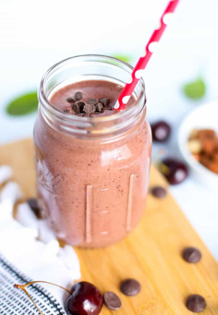 cherry smoothie in mason jar with straw
