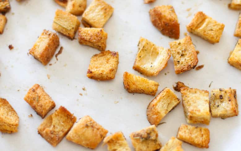 Homemade croutons on parchment paper.