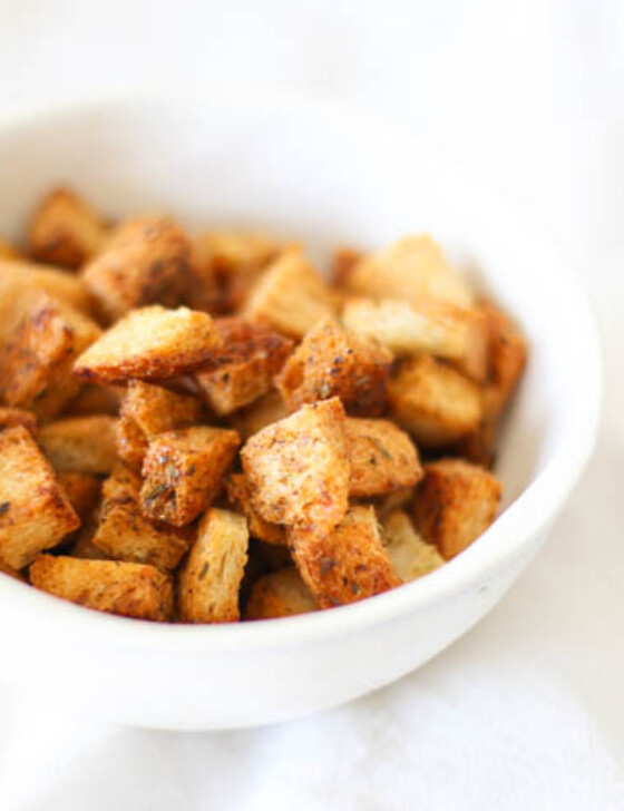 Homemade croutons in a white bowl.