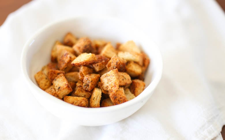 Homemade croutons in a white bowl