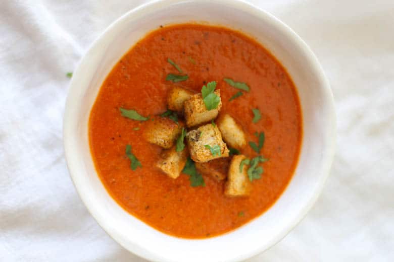 Homemade croutons on top of tomato soup.