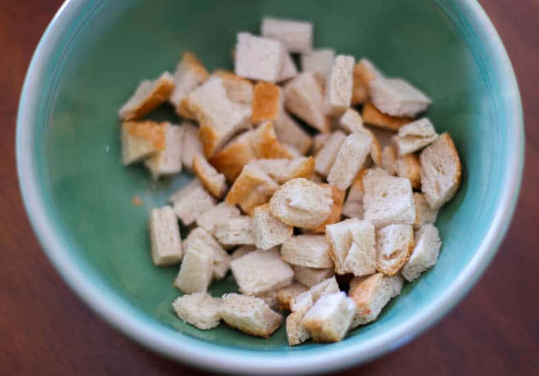 Sourdough bread cut up in a bowl to be made into homemade croutons.