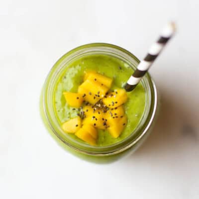 green smoothie with mango and chia in mason jar with straw