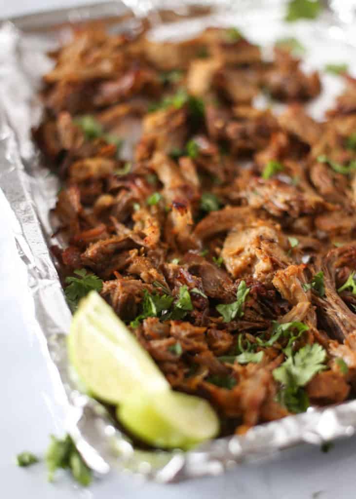 Instant Pot Carnitas Shredded on a foil lined baking sheet