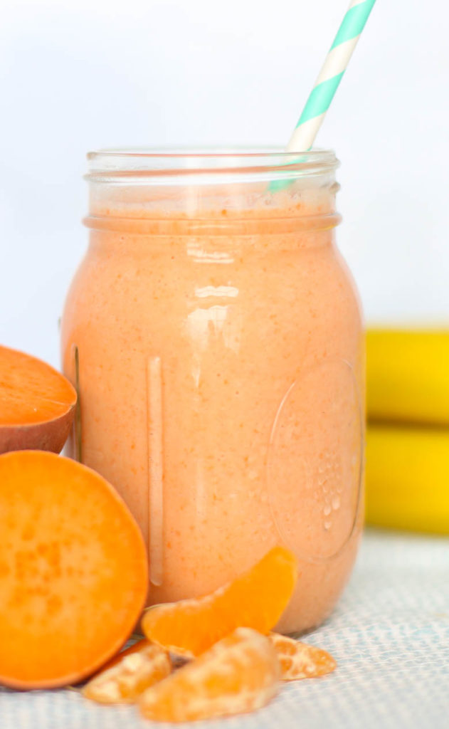 Orange smoothie in mason jar with straw