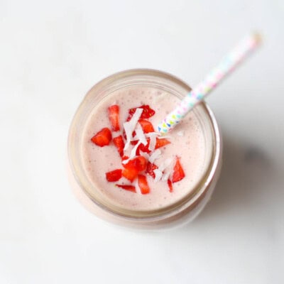strawberry smoothie in mason jar with straw