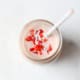 strawberry smoothie in mason jar with straw