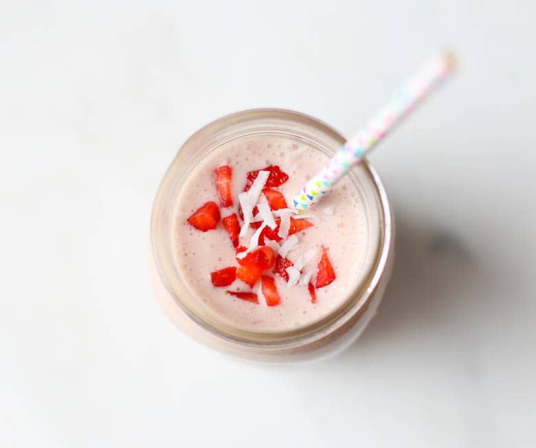 strawberry smoothie in mason jar with straw