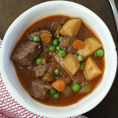 bowl of stew in white bowl with napkin