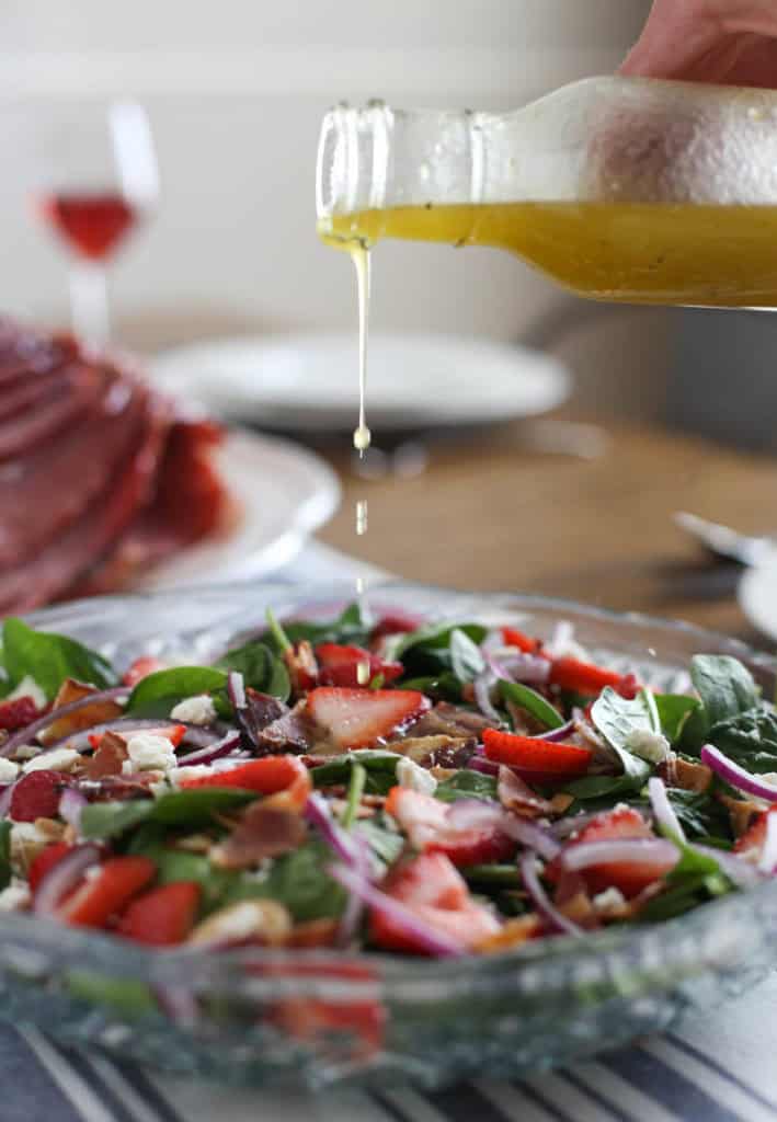 spinach salad on table and dressing