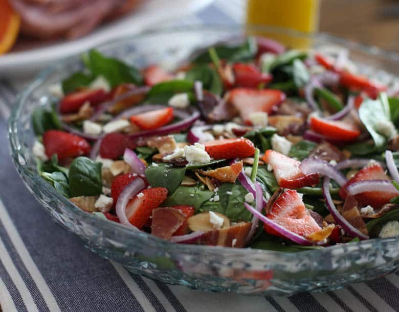 A make ahead spinach salad on table for Easter.