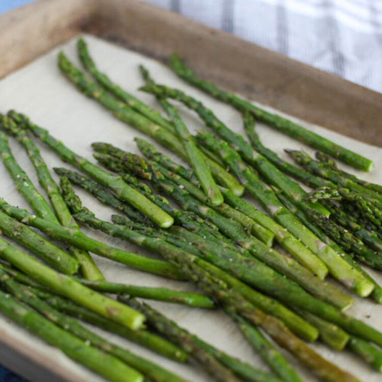 Oven roasted asparagus on a baking sheet.