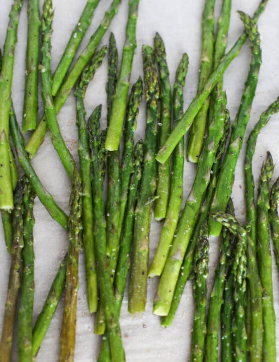Oven roasted asparagus on parchment paper.