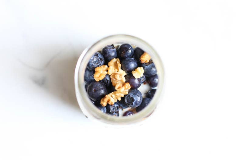 Looking into the top of a mason jar that has blueberry overnight oats ready to eat.