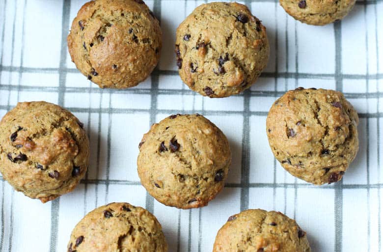 chocolate chip banana muffins on a tea towel