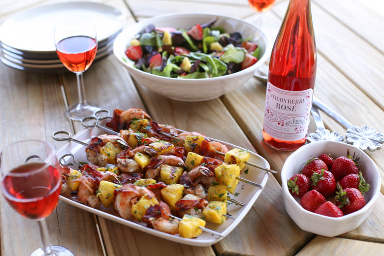 Strawberry avocado salad, kabobs, strawberries on a wooden table.