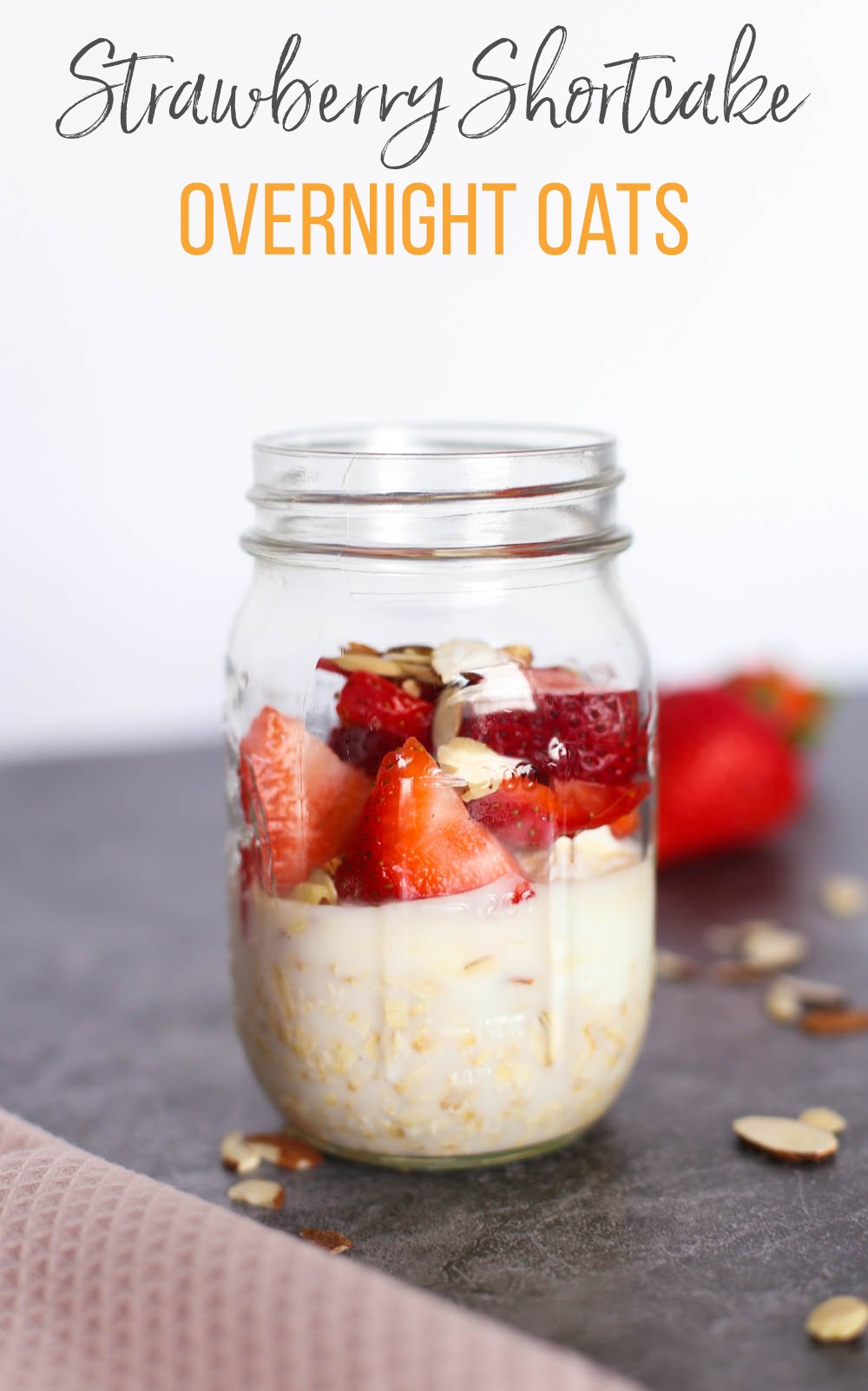 Strawberry shortcake overnight oats ingredients layered in a mason jar.