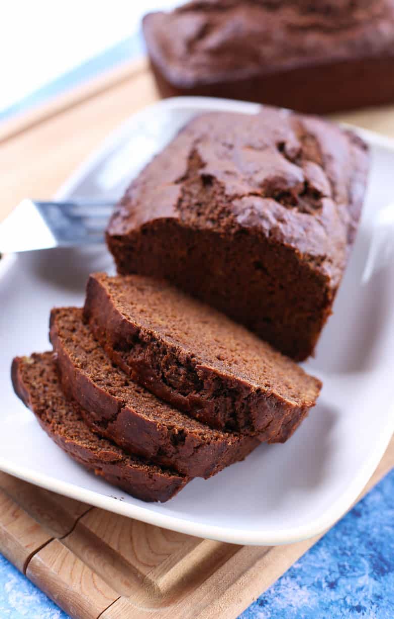 Chocolate banana bread slices on a white plate.