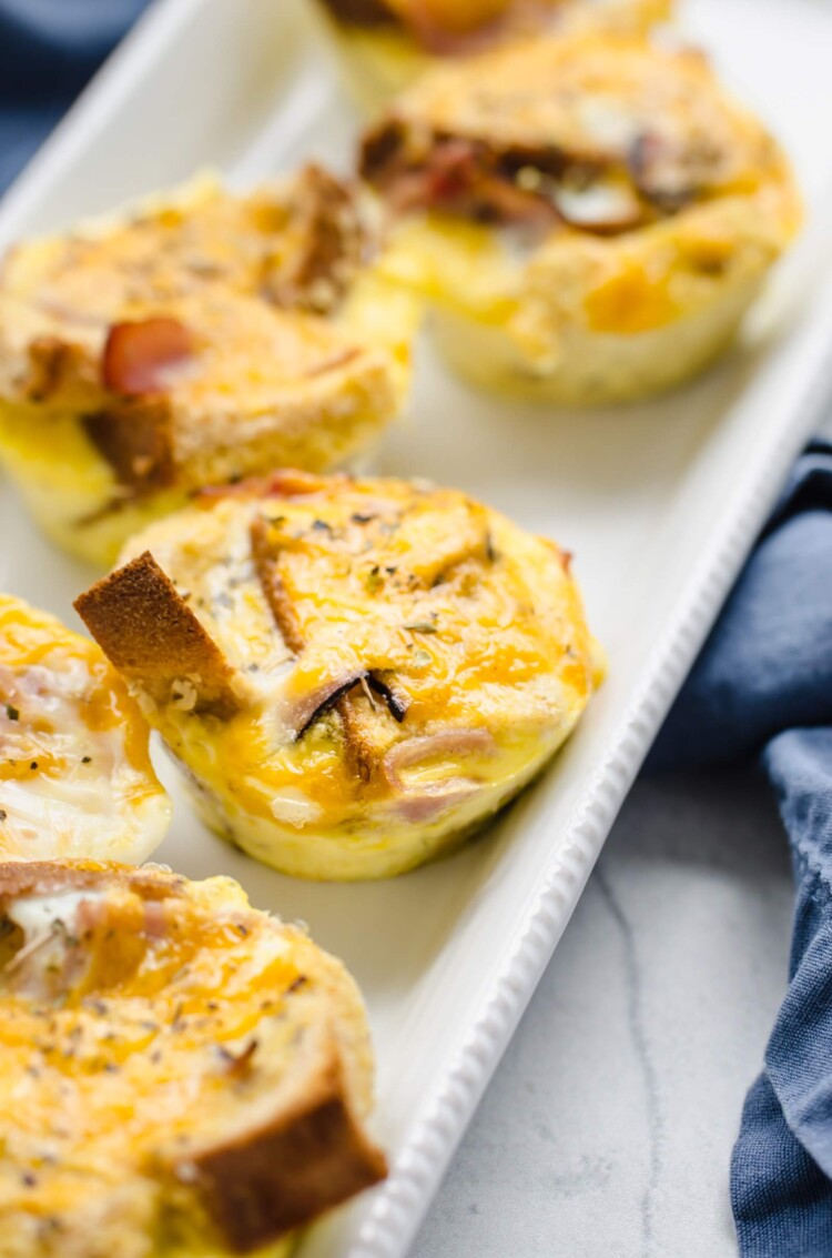 Breakfast casserole muffins on a white serving dish.