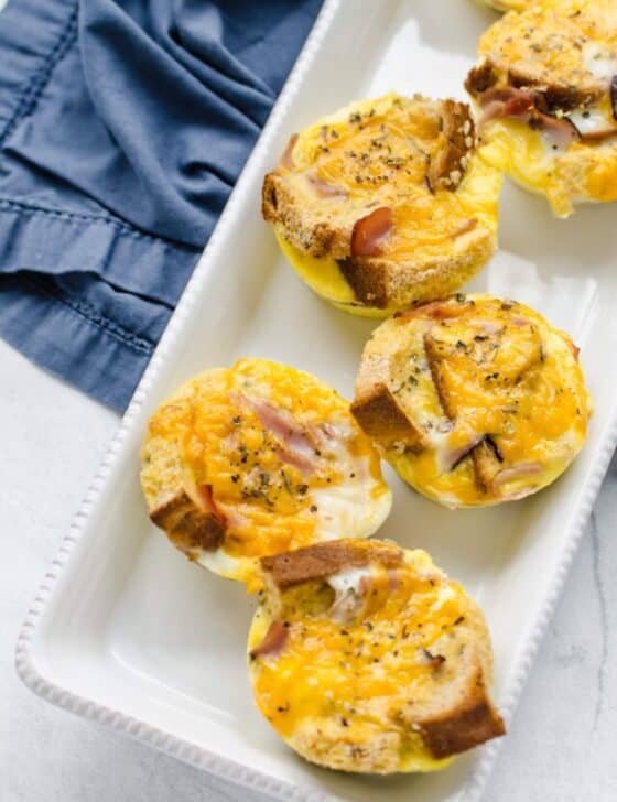 Egg muffins lined up on a white platter.