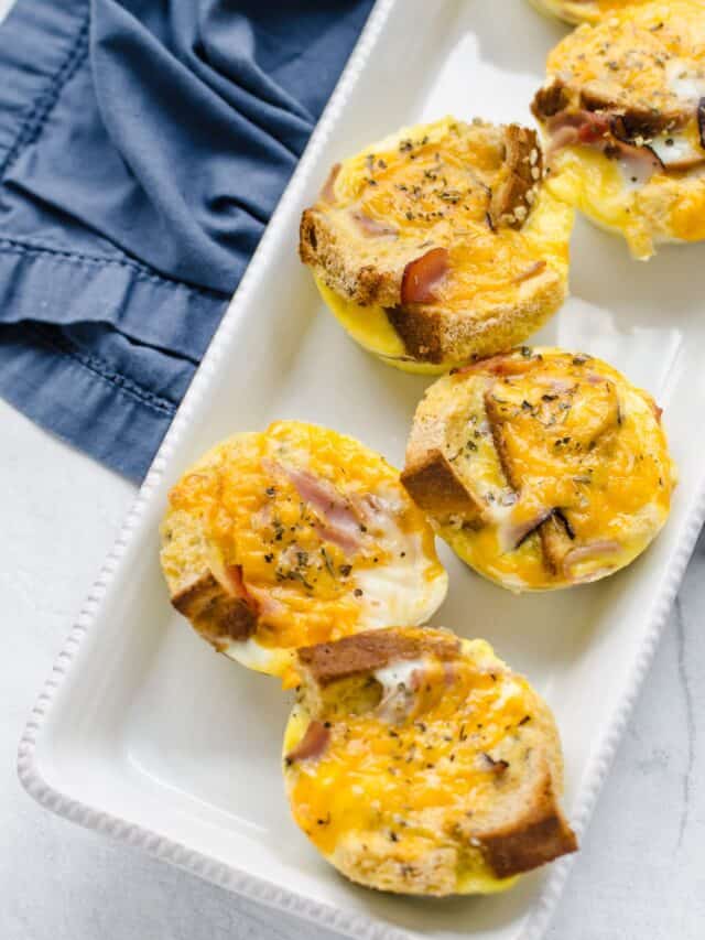 Egg muffins lined up on a white platter.