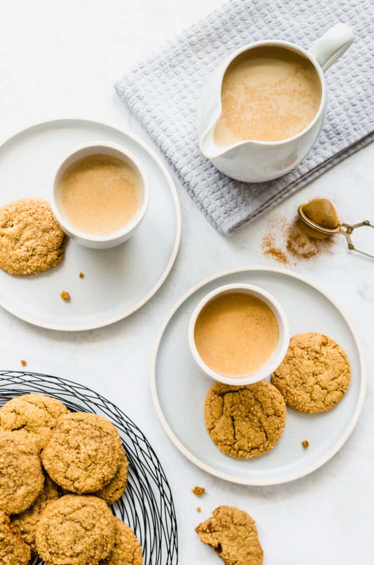 pumpkin spice latte in mugs with cookies.