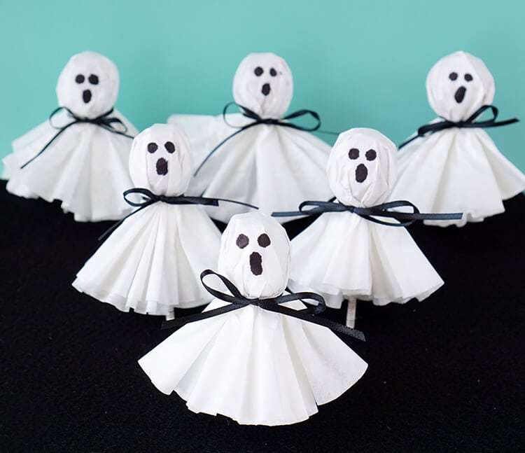 Coffee Filter Ghost Lollipops lined up on a pyramid for the picture.